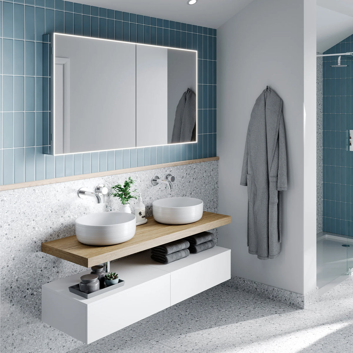 HiB Exos 100 illuminated mirror cabinet in blue tiled bathroom